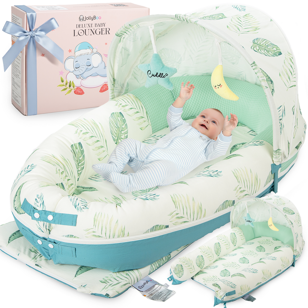 Baby in a green and white baby lounger with a matching box in the background