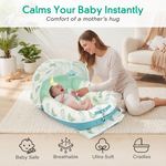 Woman sitting with a baby in a green and blue baby lounger in a cozy living room.