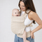 Woman holding her baby in a newborn carrier